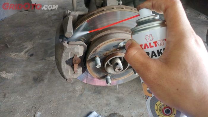 bersihkan rem dengan menyemprotkan brake cleaner