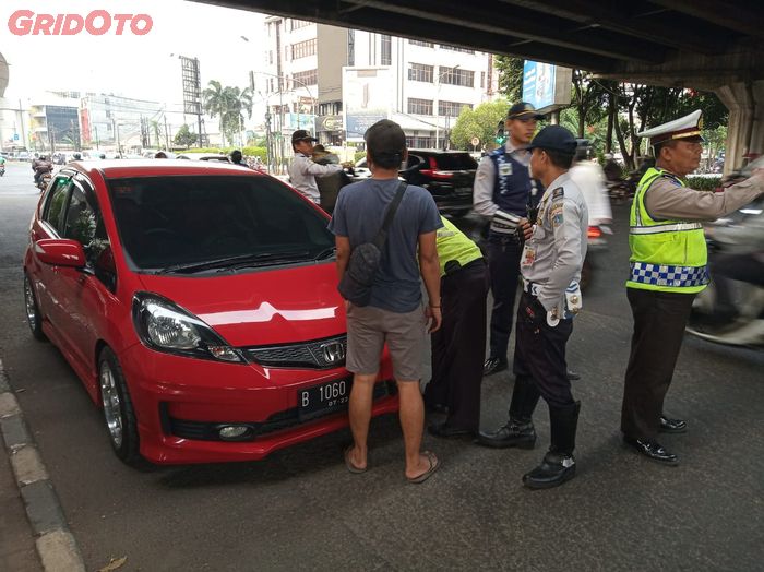 Honda Jazz berkelir merah yang terkena tilang di perluasan ganjil genap sekitaran jalan RS Fatmawati, Jakarta Selatan.