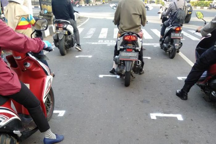 Garis yang sengaja dibuat Dishub Tuban di lampu merah (traffic light) simpang Kembang Ijo, Tuban, dalam rangka penegakan aturan physical distancing.