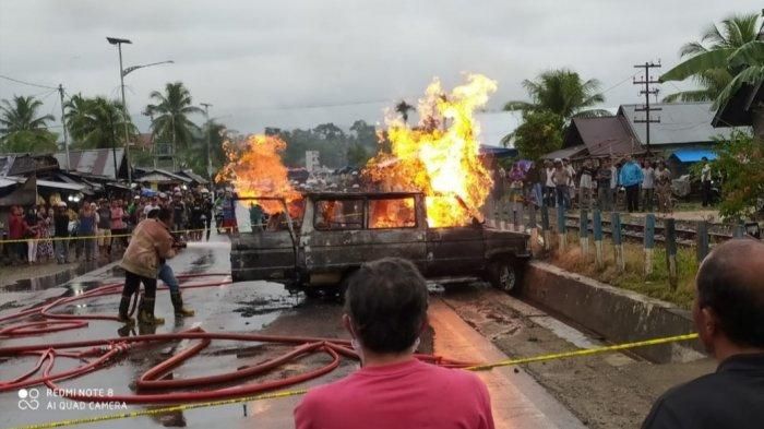 Mobil Toyota Kijang terbakar di depan SPBU Lubuk Alung, Sumbar, Minggu (21/6/2020). (Istimewa)