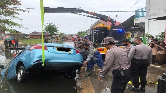 Proses evakuasi Toyota Vios Limo milik Blue Bird yang nyemplung kali di kota Padang, Sumatera Barat