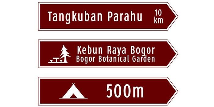 Contoh papan penunjuk jalan berwarna cokelat.