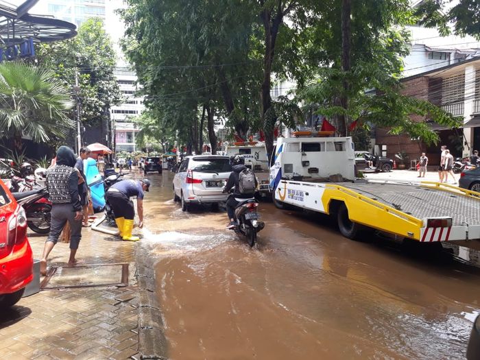 Mobil towing yang sedang menunggu mengangkut kendaraan yang terendam banjir.