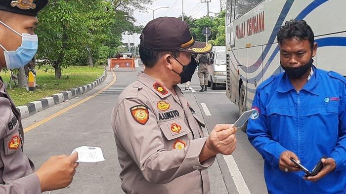 Kasitipol Polrestabes Surabaya,Kompil A Lukito memeriksa kelengkapan dokumen dinatranya hasik Swab Test Antigen milik sopor Bus jurusan Surabaya Madura. 