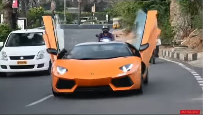 Pemilik Lamborghini Aventador asal India ini buka kedua scissor door di tengah jalan.