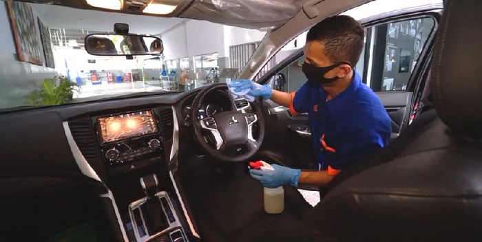 Ilustrasi  penyemprotan cairan disinfektan di kabin mobil