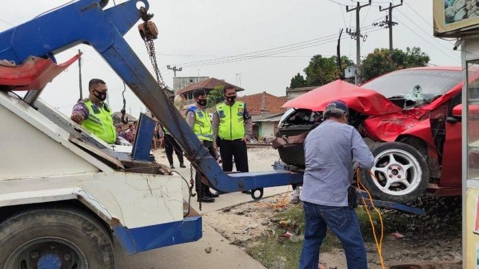 Proses evakuasi Honda Brio yang tertabrak kereta api di perlintasan Seneja, Sukmajaya, Jombang, Cilegon, Banten