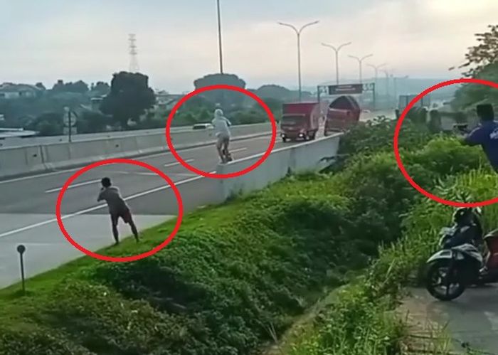Sekelompok pemuda ikut merekam truk oleng di pinggir jalan tol.