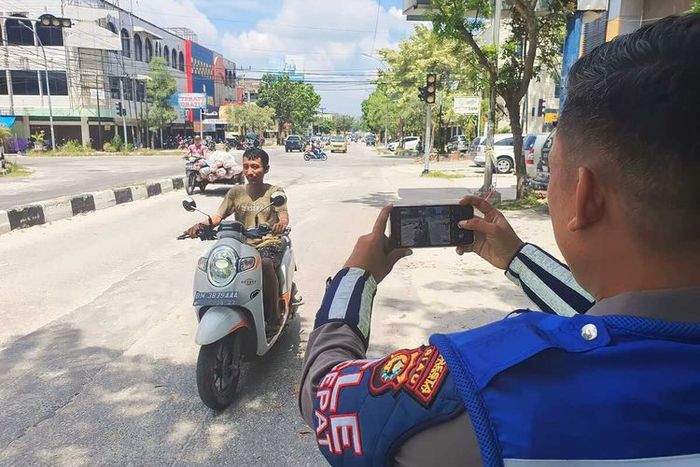 Petugas Satlantas Polresta Pekanbaru melakukan uji coba penerapan tilang ETLE mobile untuk menindak pelanggar lalu lintas di Kota Pekanbaru, Riau, Kamis (25/5/2023).(Dok. Satlantas Polresta Pekanbaru) 