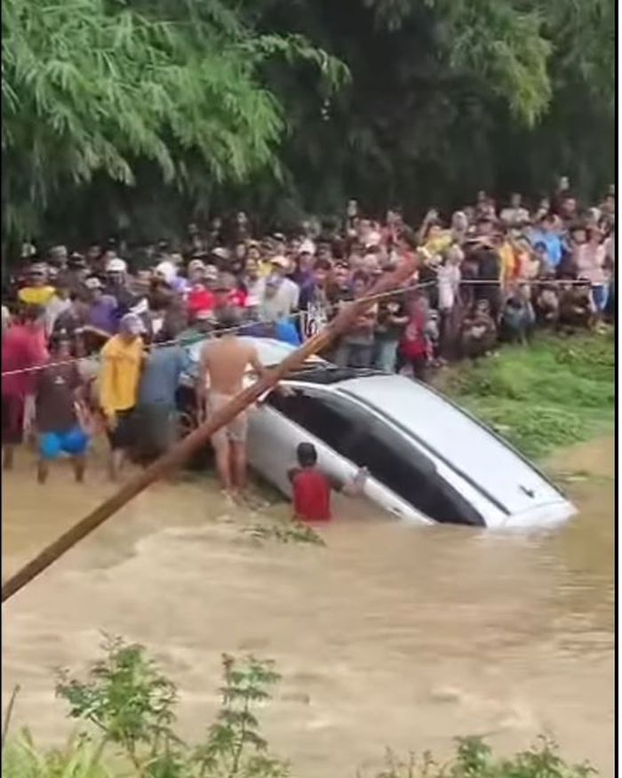 Warga beramai-ramai mengevakuasi Toyota Rush yang terseret banjir di Kp Nawit, desa Kertarahayu, Setu, kabupaten Bekasi, Jawa Barat, (4/3/25) pagi.