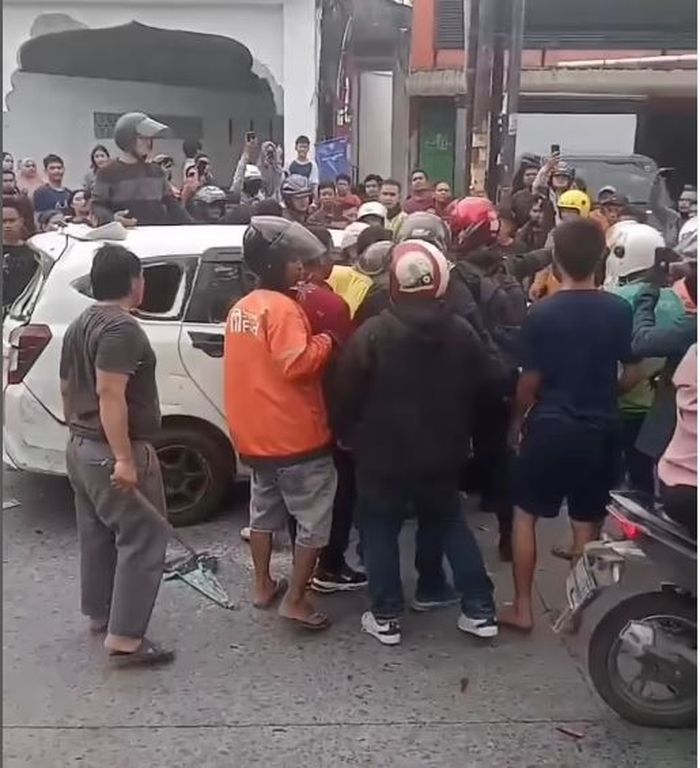 Warga merusak Daihatsu Sigra yang diteriaki pemotor 'maling' padahal hanya karena serempetan di jalan Sisingamangaraja, Kota Medan, Sumatera Utara