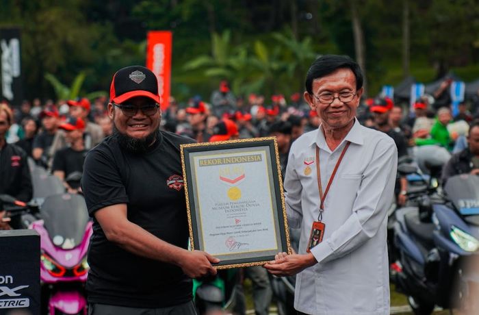 Jusuf Ngadri, Direktur Operasional MURI, menyerahkan piagam Rekor MURI ke perwakilan PEVR