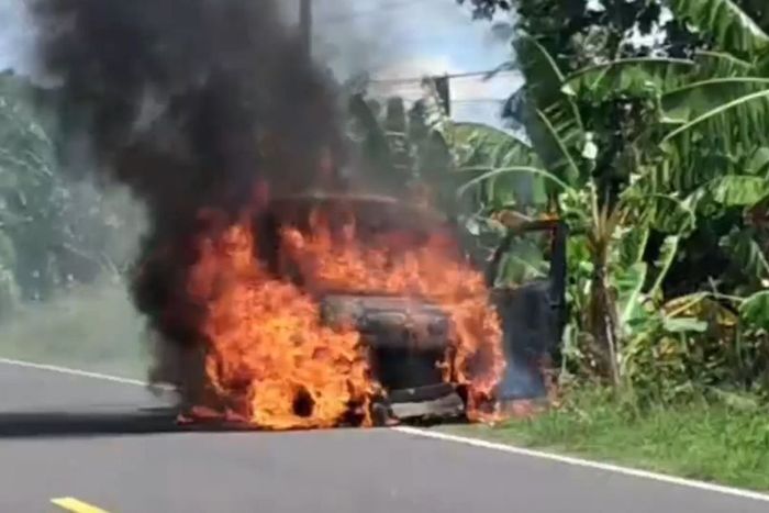 Kondisi saat api masih membakar Daihatsu Gran Max pengangkut uang Rp 4,6 miliar milik Bank BNI di jalan raya Majene-Mamuju, desa Palippis, Balanipa, Polewali Mandar, Sulawesi Barat, (12/11/25)