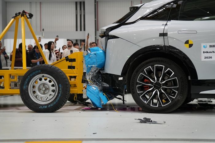 Detail kerusakan bagian belakang mobil setelah uji tabrak 84 km per jam, memperlihatkan deformasi pada bemper dan pintu bagasi.