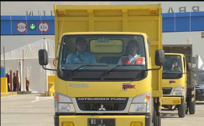 Jokowi bersama pria berbaju biru meresmikan tol Ngawi-Kertosono menggunakan truk Fuso.