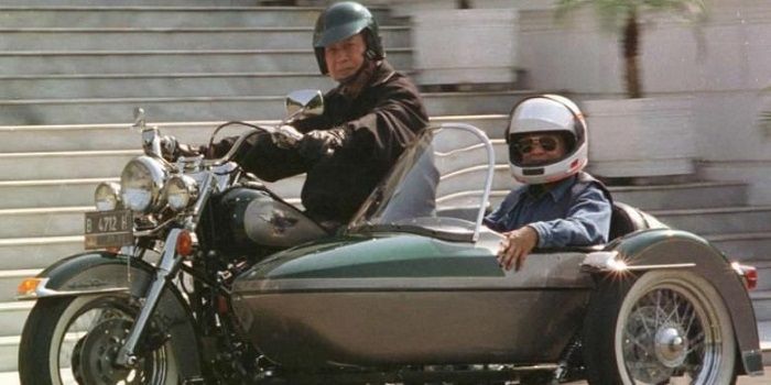 Presiden Soeharto dan Menteri Riset dan Teknologi BJ Habibie mengendarai Harley Davidson di halaman 