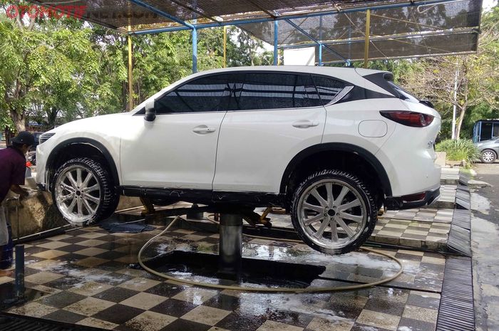 Mencuci mobil di car wash dengan hidrolik