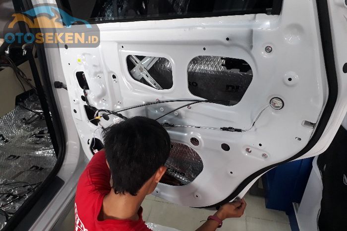 Proses pemasangan peredam di pintu mobil