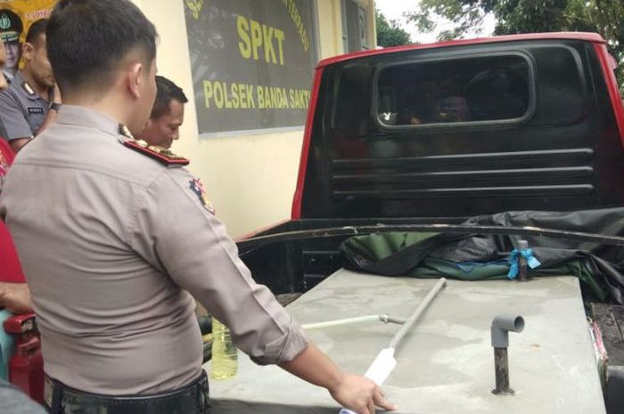 Polisi memperlihatkan mobil yang sudah dimodifikasi untuk membeli bahan bakar minyak jenis premium bersubsidi di SPBU