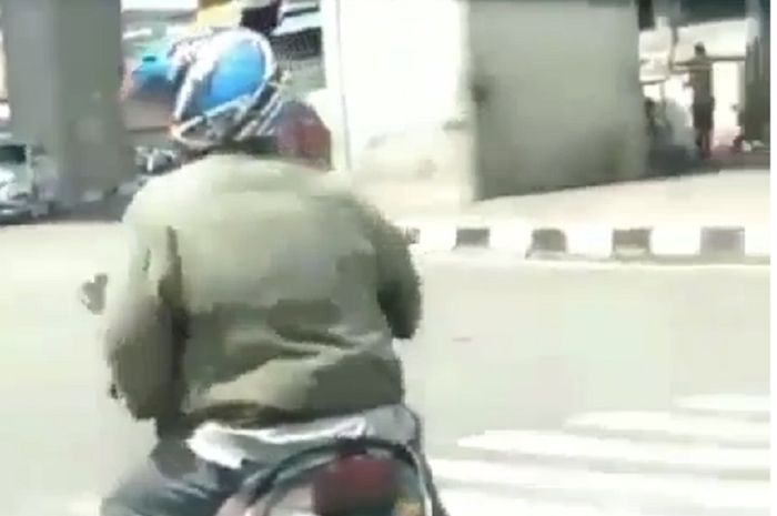 Seorang pemotor ogah menurunan kaki saat di lampu merah