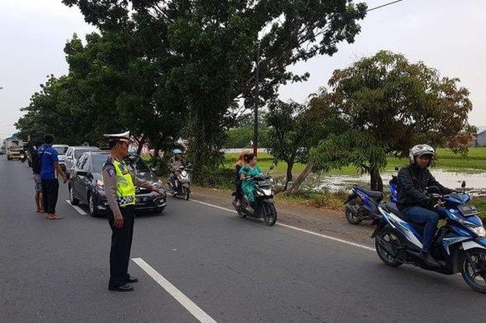 Polisi saat mengatur lalu lintas seusai kecelakaan yang menewaskan pengemudi sepeda motor di Jalan Raya Pantura Widasari Depan U-turn Sinar Jaya 2 Kecamatan Widasari, Kabupaten Indramayu, Kamis (21/11/2019).