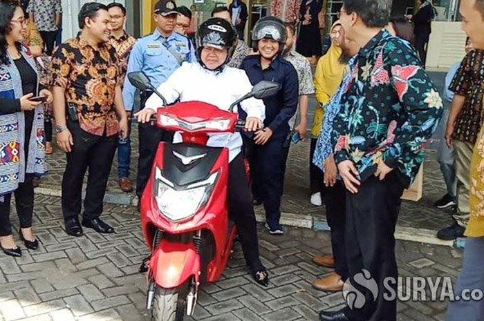 Wali Kota Surabaya, Tri Rismaharini mengendarai sepeda motor listrik anyarnya. 