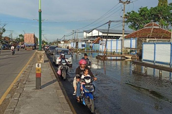Air mulai menggenangi jalur Pantura Kudus-Semarang KM 10 atau di depan PT HIT Sayung Demak, Jawa Tengah, Minggu (22/3/2020) 