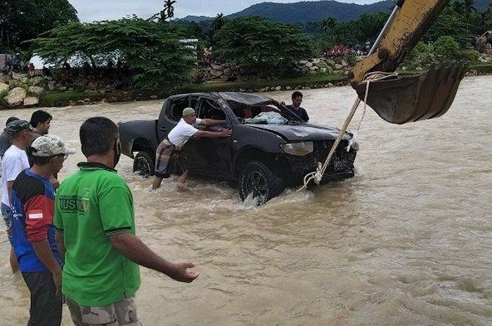 Alat berat dari BPBK Abdya, bersama warga mengevakuasi mobil double cabin yang tenggelam banjir luapan di Krueng Beukah, Blangpidie, Sabtu (23/5/2020). 