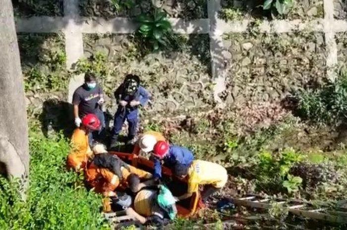 Petugas mengevakuasi pengendara motor yang tercebut ke parit sedalam empat meter di Lebak Bulus, Cilandak, Jakarta Selatan, Selasa (20/10/2020) 