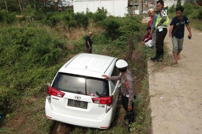 Toyota Kijang Innova terguling ke lahan kosong saat berusaha belok kiri di tanjakan Jl Sawerigading, Sengkang, kabupaten Wajo, Sulawesi Selatan