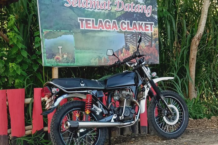 Honda GL100 yang terparkir di depan gerbang tempat wisata Telaga Claket.
