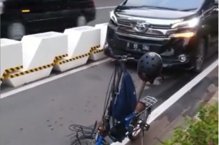Toyota Vellfire diadang sepeda lipat karena terobos jalur sepeda permanen Jl Jenderal Sudirman, Jakarta Pusat