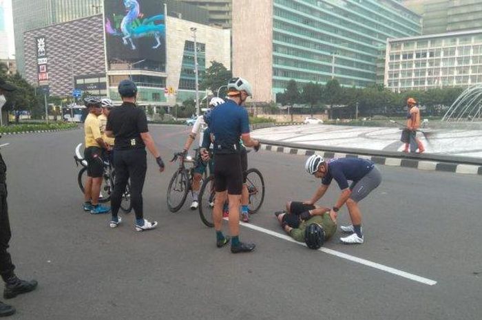 Petugas keamanan menolong pesepeda yang menjadi korban tabrak lari, di Bundaran Hotel Indonesia, Jalan MH Thamrin, Jakarta Pusat, Jumat (12/3/2021) pagi. 