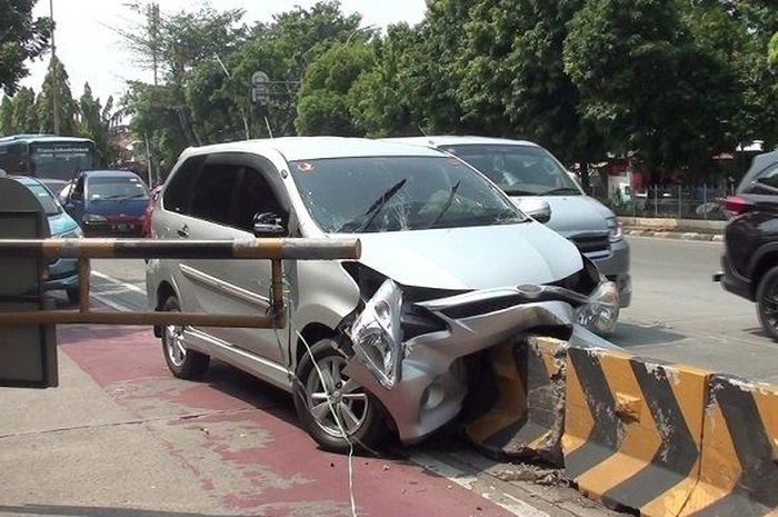 Toyota Avanza tusuk beton separator busway di Jalan Raya Ahmad Yani, Pulogadung, Jakarta Timur karena membuntuti bus Transjakarta