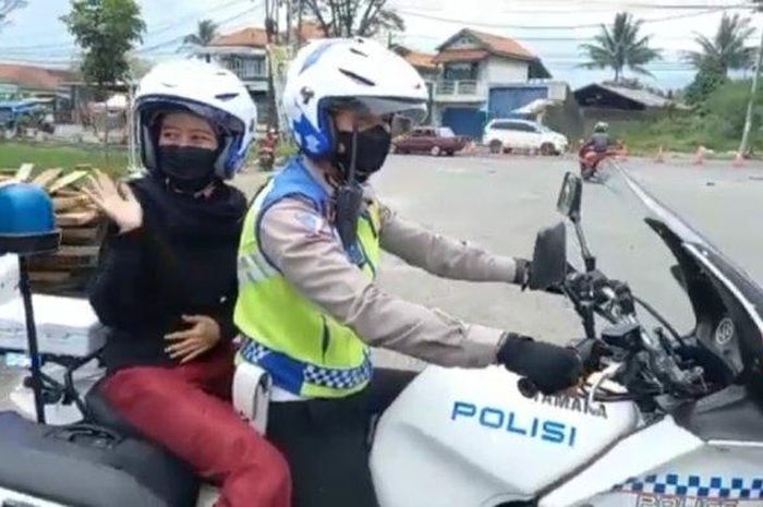 Seorang wanita yang sedang hamil di Garut meminta dibonceng motor gede anggota Polres Garut, Minggu (23/1/2022). 