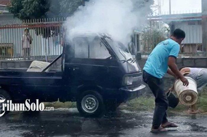 Warga berusaha memadamkan api yang membakar Suzuki Carry Pikap di Gumulan, Klaten Tengah, Klaten
