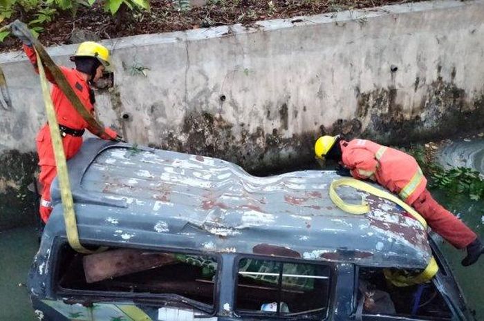 Proses evakuasi mikrolet dari dalam selokan berisi comberan hitam di Jl Ahmad Yani, Wonokromo, Surabaya