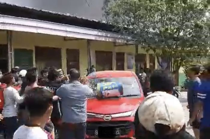 Daihatsu Sigra merah yang diamuk massa saat terjadi kebakaran di wilayah Medan Satria, kota Bekasi