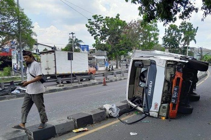 Truk Boks Isuzu Elf terguling di ringroad selatan Bantul Yogyakarta setelah menusuk Toyota Rush di tikungan