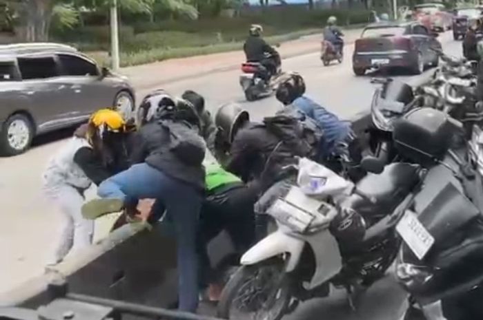 Tangkapan layar yang menampilkan puluhan pemotor gotong-royong membongkar beton separator busway di Jl Yos Sudarso arah Kelapa Gading, Jakarta Utara