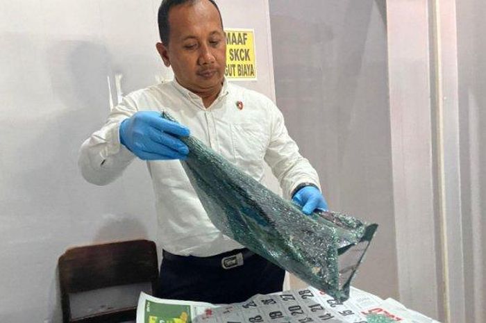 KBO Satreksrim Polres Ponorogo, Ipda Triyono menunjukan barang bukti pecahan kaca Toyota Fortuner dalam kasus maling pecah kaca menggasak uang Rp 350 juta