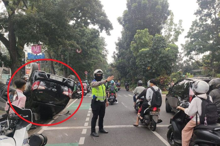 Dalam lingkaran merah, Daihatsu Ayla yang telentang tatap langit di jalan raya Pajajaran, kota Bogor, Jawa Barat