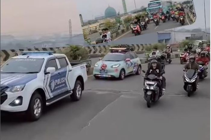 Mobil listrik Wuling Binguo EV yang memamerkan strobo dan klakson telotet dengan iringan patwal Polisi di flyover Ciputat, Tangerang Selatan