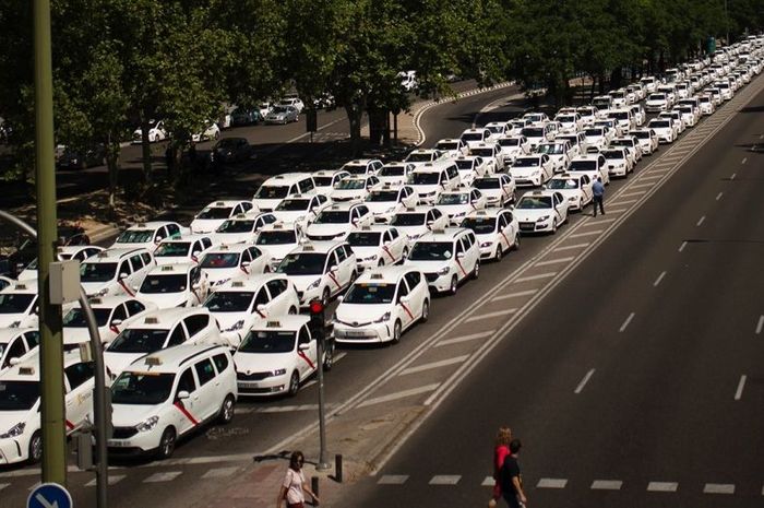 Taksi konvensional Madrid melakukan aksi di tengah jalan, Senin (30/7)