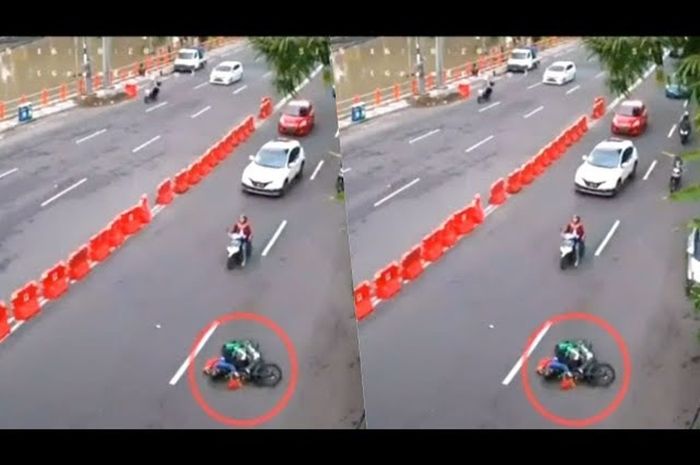 Seorang pengendara motor yang terjatuh gara-gara masih nekat pakai jas hujan model ponco