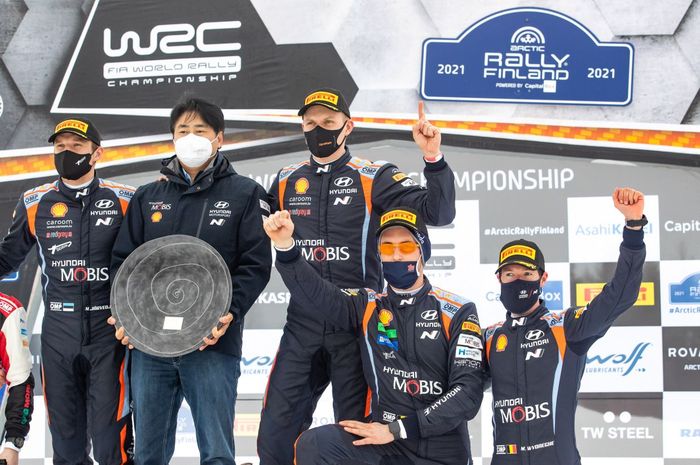 Pereli tim Hyundai, Ott Tanak (ketiga dari kiri) dan rekan setimnya Thierry Neuville (pakai kacamata oranye) merayakan sukses mereka di podium Reli Finlandia 2021