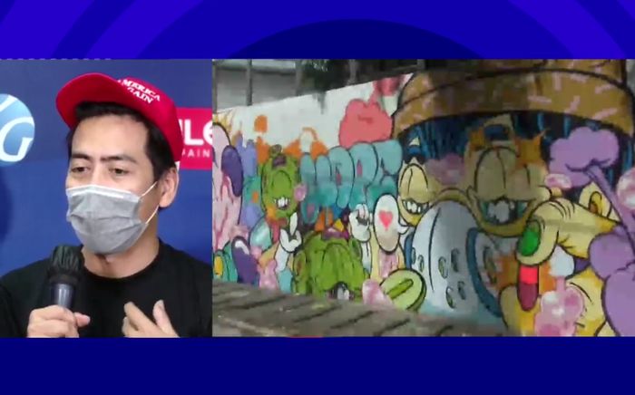 Seniman WD Willy dan salah satu mural di #RepaintIndonesia