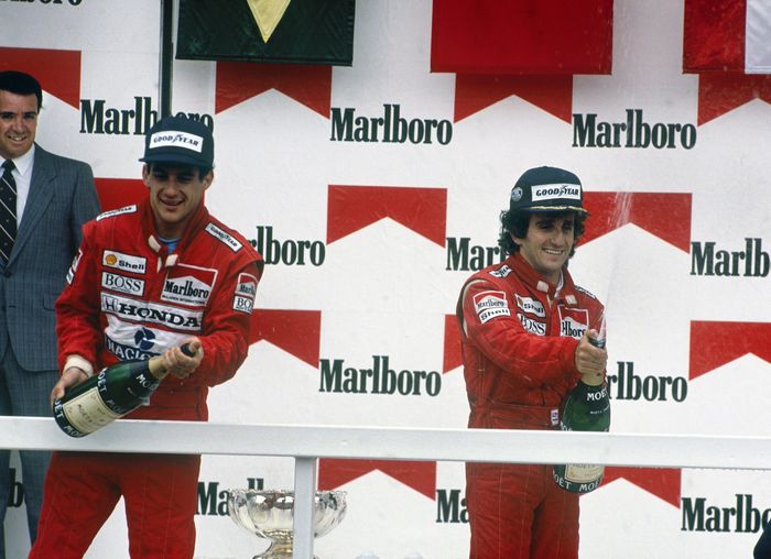 Alain Prost (kanan) dan rekan setimnya di McLaren, Ayrton Senna di podium GP F1 Meksiko 1988