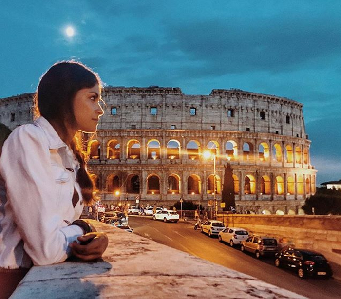 Linda Morselli menikmati pemandangan di sekitar koloseum, bangunan peninggalan bersejarah di Roma, Italia