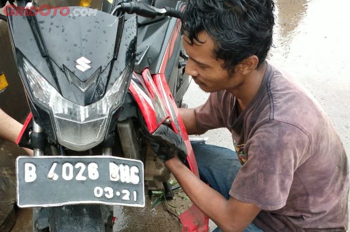 Yusup membantu warga menyalakan motornya